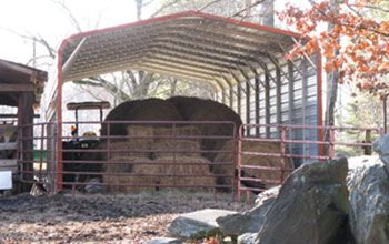 An excellent use of space, this sturdy and gorgeous metal covered area for hay and tractor.